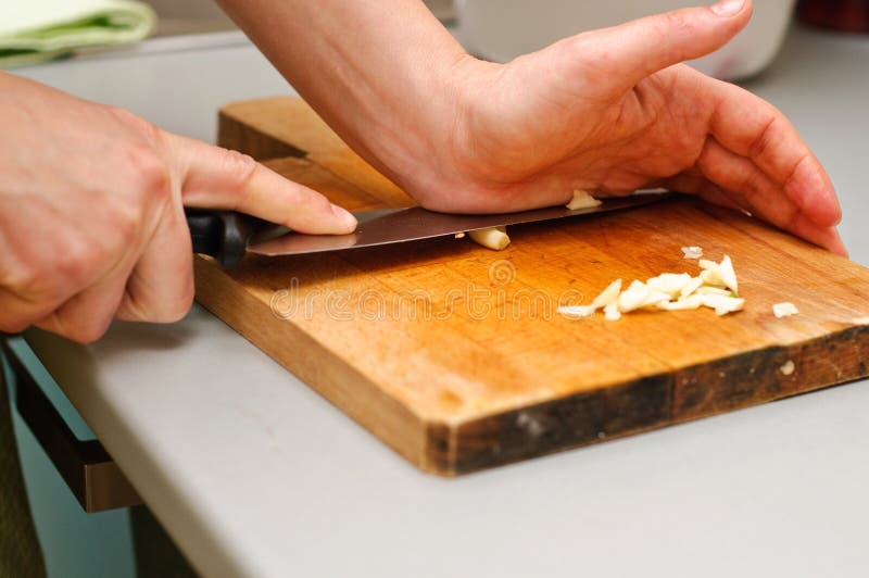 Crushing garlic stock photo. Image of garlic, board, cooking 23131556