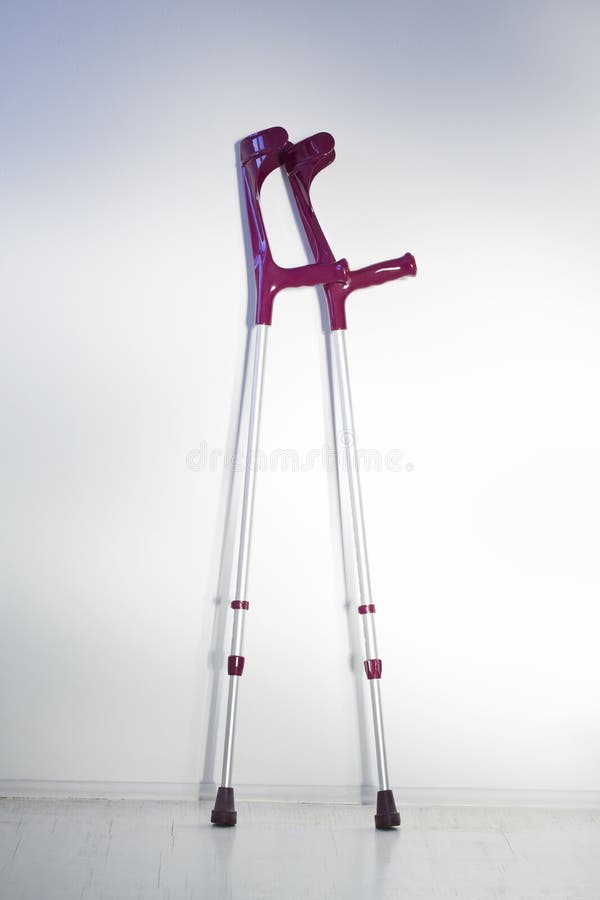 Young Woman after Knee Surgery. on Crutches, in an Orthosis and with