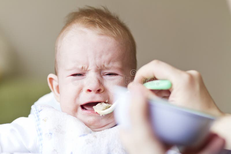Crying Baby Eating Porridge Royalty Free Stock Photo - Image: 29360055