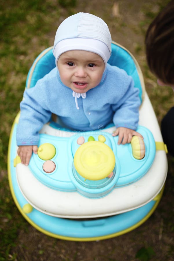 Crying Cute Baby in Baby Walker Walks Outdoors Stock Photo Image of toldier, babyhood 61426740