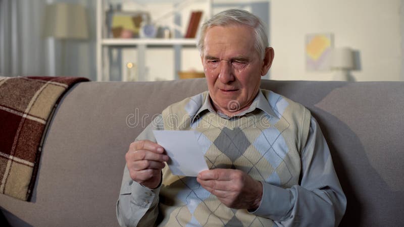 Crying senior widower holding photo, missing wife after funeral, nostalgia royalty free stock photography Crying senior widower holding photo, missing wife after funeral, nostalgia royalty free stock photography