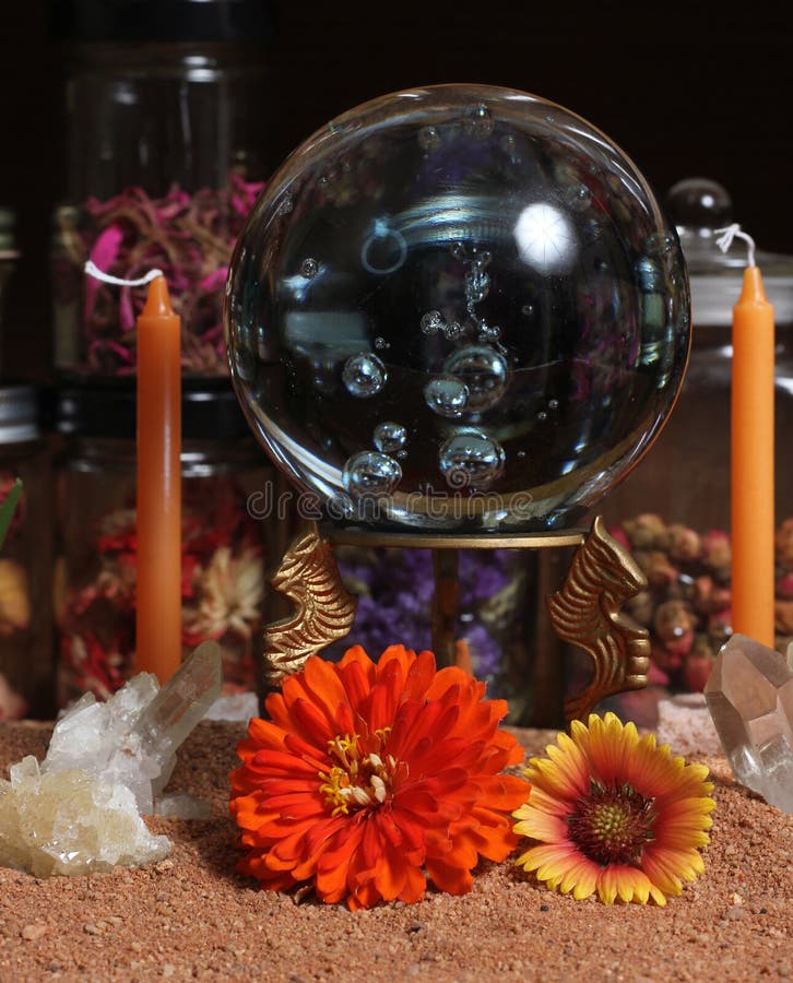 Crystal Ball with Flowers and Candles on Meditation Table Stock Image