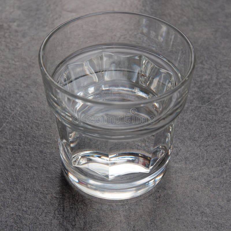 Crystal Clear Glass of Water on Grey Marble Table Background Stock