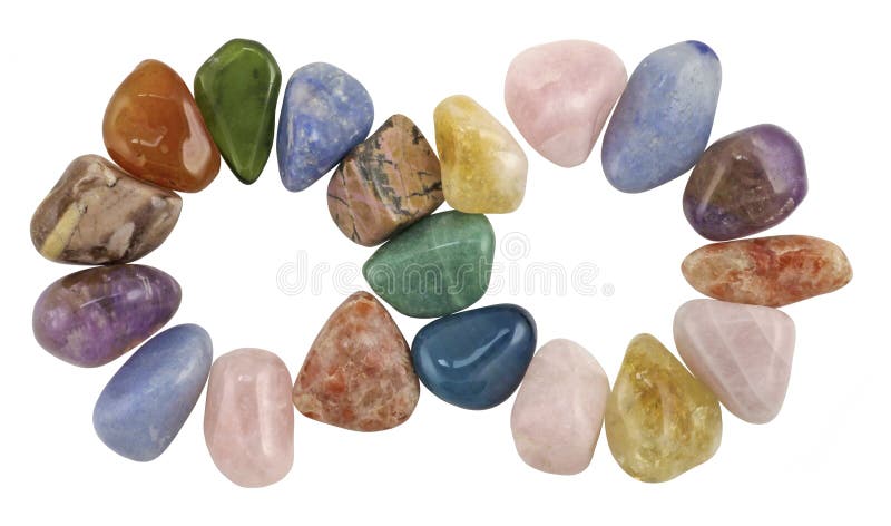 Multi colored tumbled crystal gem stones shaped to form an infinity symbol, on a white background. Multi colored tumbled crystal gem stones shaped to form an infinity symbol, on a white background