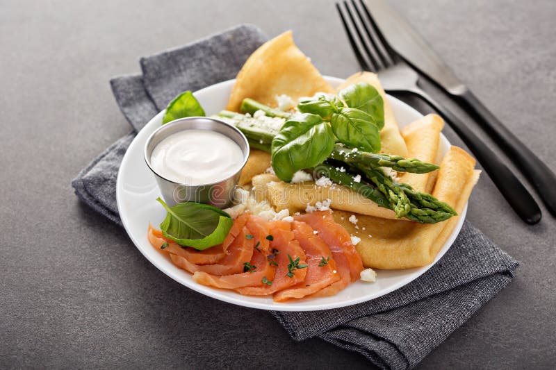Crêpe saporiti con il salmone, la panna acida e l'asparago fotografia stock Crêpe saporiti con il salmone, la panna acida e l'asparago fotografia stock