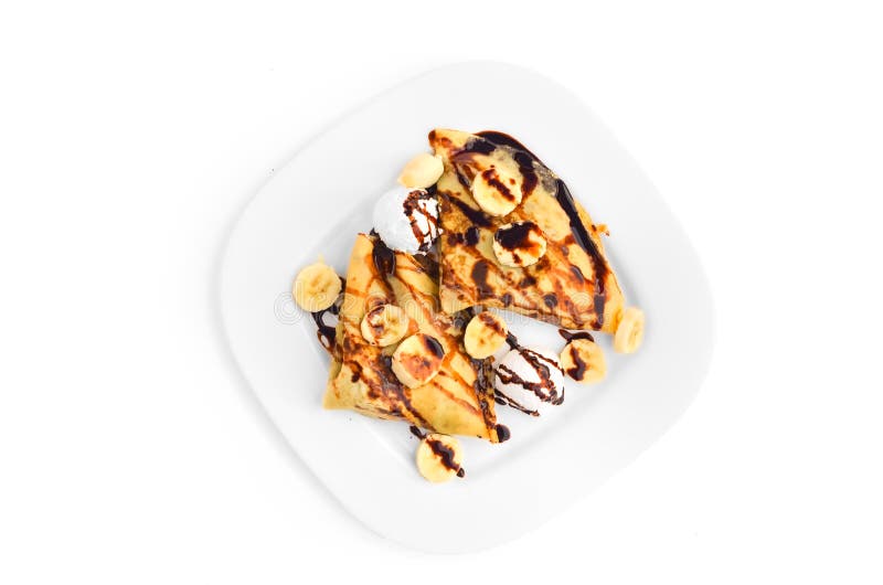 Crêpes avec la banane, la crème glacée et le habillage de chocolat - vue supérieure images stock Crêpes avec la banane, la crème glacée et le habillage de chocolat - vue supérieure images stock