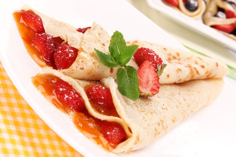 Delicious strawberry pancakes with mint leaves. Delicious strawberry pancakes with mint leaves