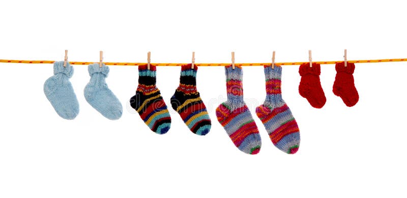 Four pairs of isolated handmade red and blue wool socks hanging on a rope. Four pairs of isolated handmade red and blue wool socks hanging on a rope.