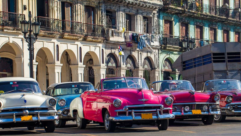 American convertible vintage cars parked on the main street in Havana Cuba.