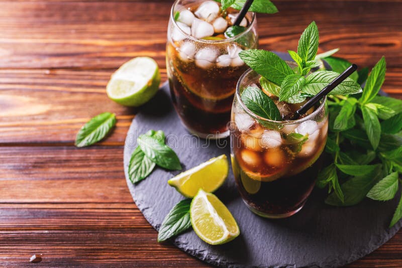 Cuba Libre cocktail with cola, lime, rum and peppermint