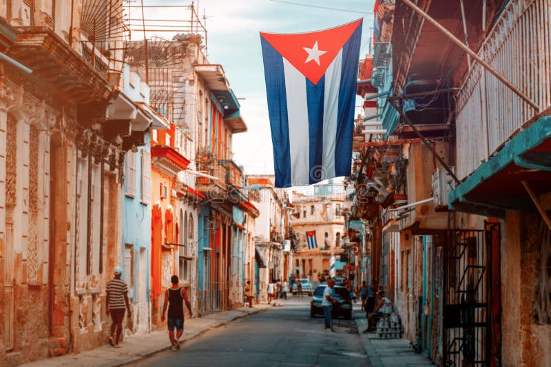 Cuban flags, people and aged buildings in Old Havana stock photography