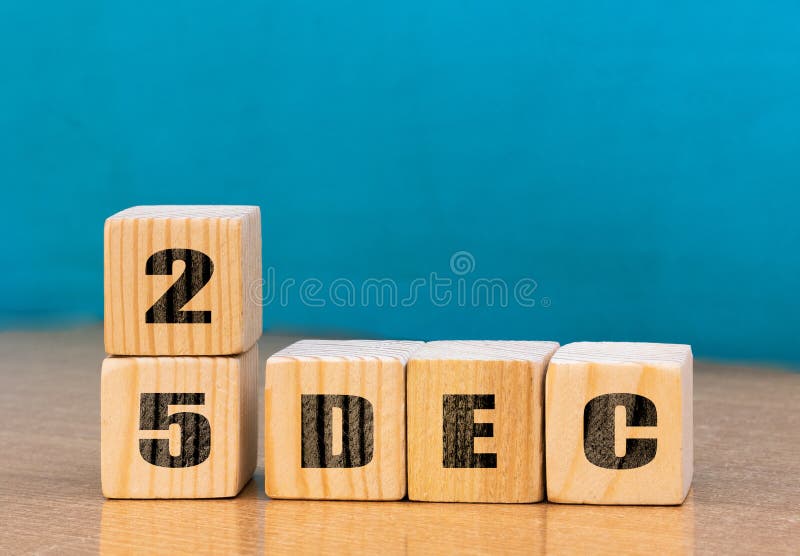 Cube shape calendar for December 25 on wooden surface with empty space for text royalty free stock image