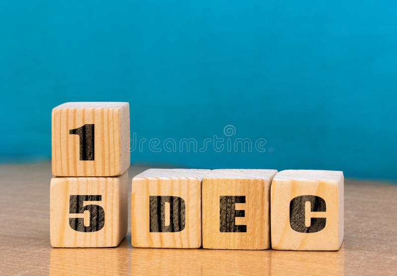 Cube shape calendar for December 15 on wooden surface with empty space for text royalty free stock photo