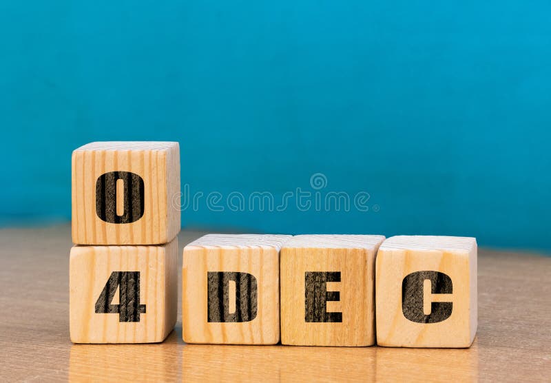 Cube shape calendar for December 04 on wooden surface with empty space for text royalty free stock photo