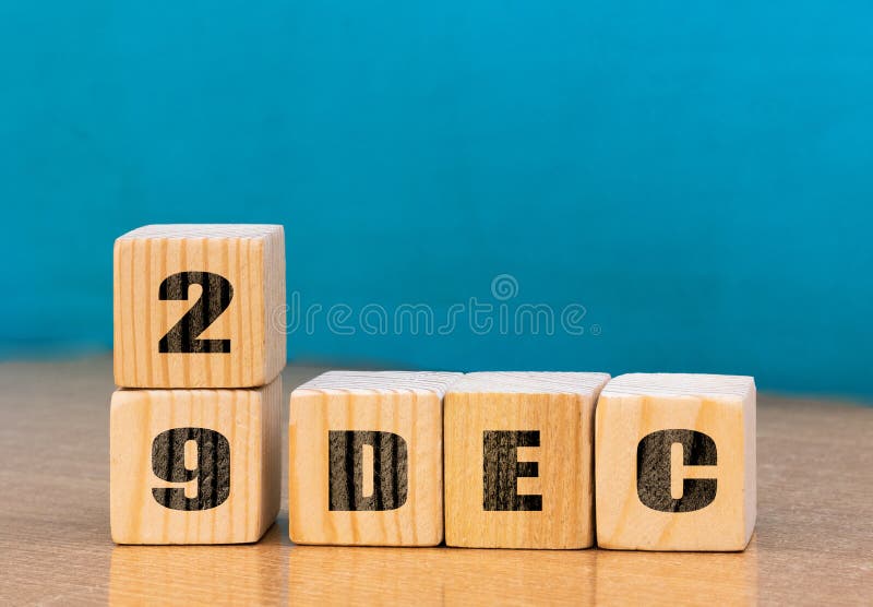 Cube shape calendar for December 29 on wooden surface with empty space for text royalty free stock image