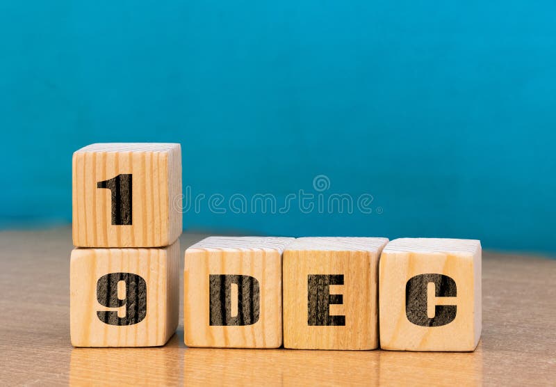 Cube shape calendar for December 19 on wooden surface with empty space for text royalty free stock images