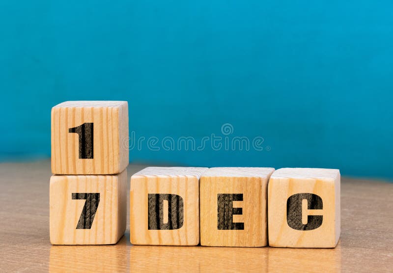 Cube shape calendar for December 17 on wooden surface with empty space for text royalty free stock image