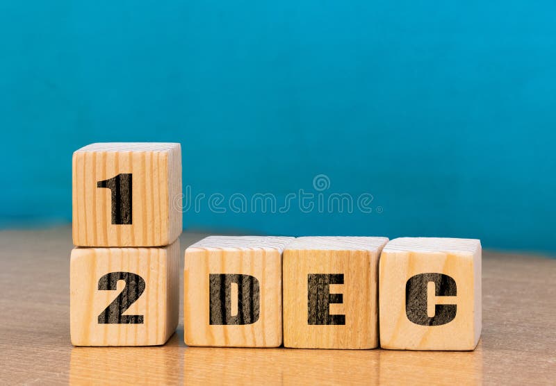 Cube shape calendar for December 12 on wooden surface with empty space for text stock photos