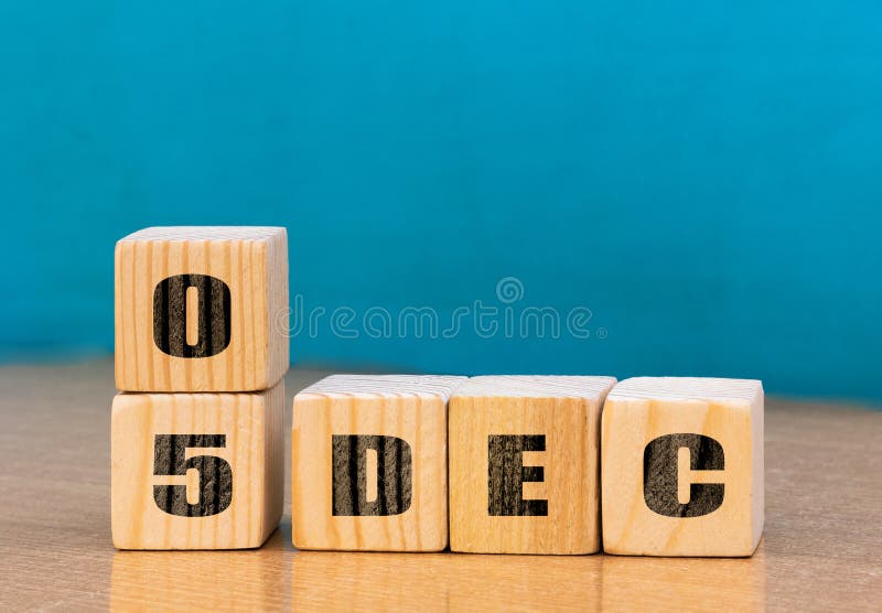 Cube shape calendar for December 05 on wooden surface with empty space for text royalty free stock image
