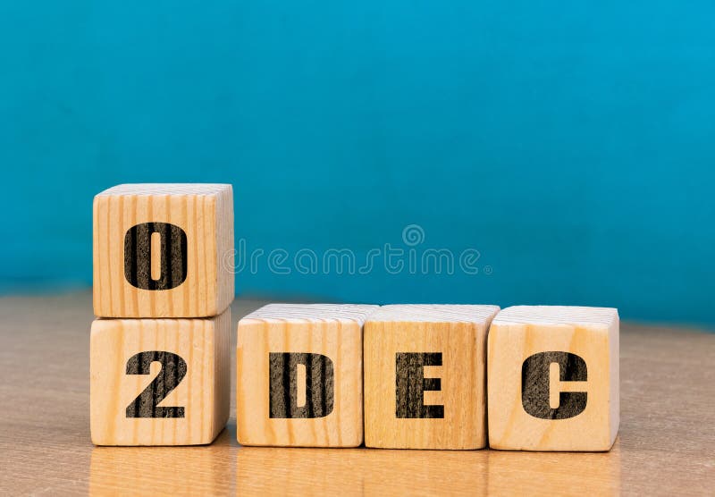 Cube shape calendar for December 02 on wooden surface with empty space for text stock photography