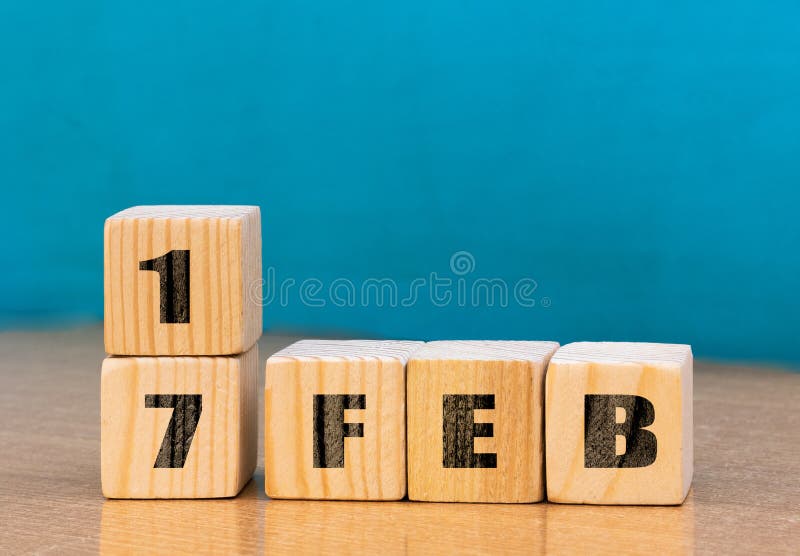 Cube shape calendar for February 17 on wooden surface with empty space for text,cube calendar for december on wood background royalty free stock image