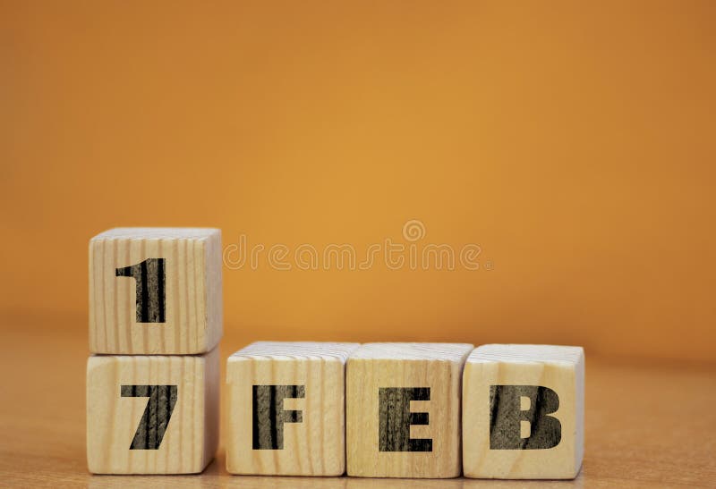 Cube shape calendar for february 17 on wooden surface with empty space for text, new year Wooden calendar with date, February cube royalty free stock image