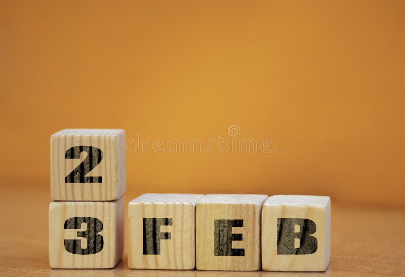 Cube shape calendar for february 23 on wooden surface with empty space for text, new year Wooden calendar with date, February cube stock photography