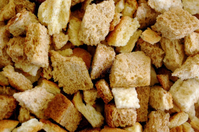 Cut into Cubes, Rye Bread is Placed on a Dark Baking Sheet, it is Sent