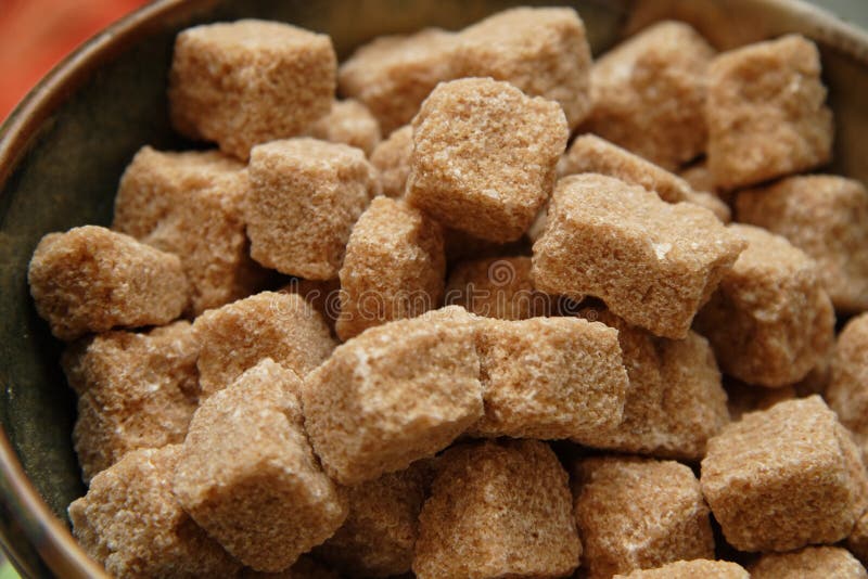 Cubes of unprocessed raw sugar in a bowl, ready for use. Cubes of unprocessed raw sugar in a bowl, ready for use