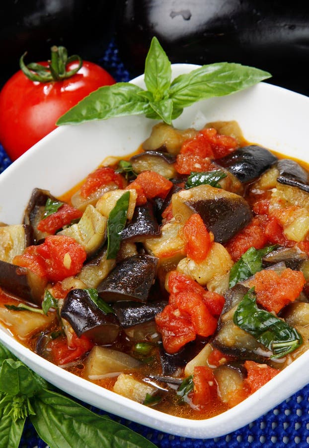 Eggplant cubes,cauliflower and tomato stew in bowl. Eggplant cubes,cauliflower and tomato stew in bowl