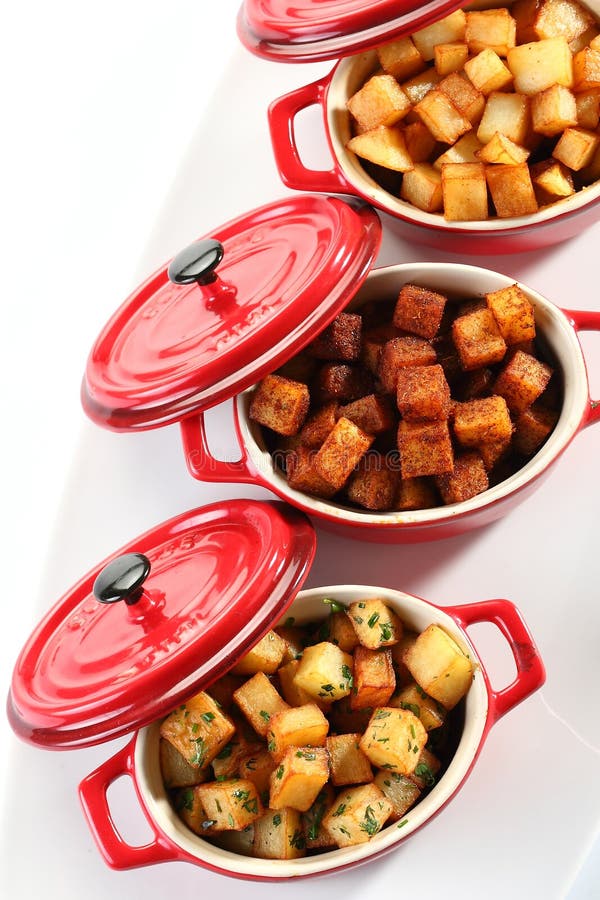 Potatoes cubes in a red steel Casserole. Potatoes cubes in a red steel Casserole