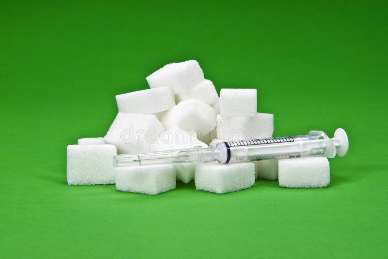 Sugar cubes with a syringe as a symbol for diabetes. Sugar cubes with a syringe as a symbol for diabetes