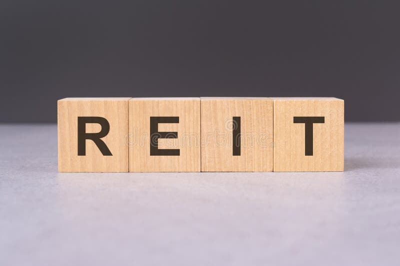 Cubes form the word reit. word concept - finance, market and investment royalty free stock photography
