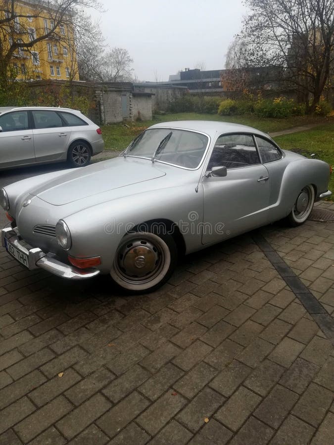 Old car standing on the cobblestones photographed in one of the courtyards of Tallinn. Old car standing on the cobblestones photographed in one of the courtyards of Tallinn