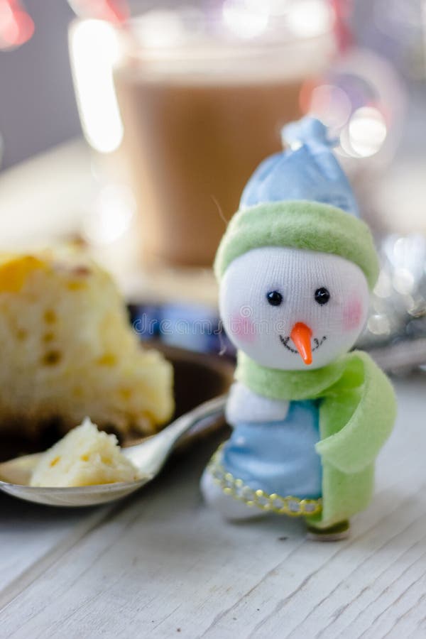 Christmas snowman holding metal spoon with the piece of christmas pie. Christmas snowman holding metal spoon with the piece of christmas pie