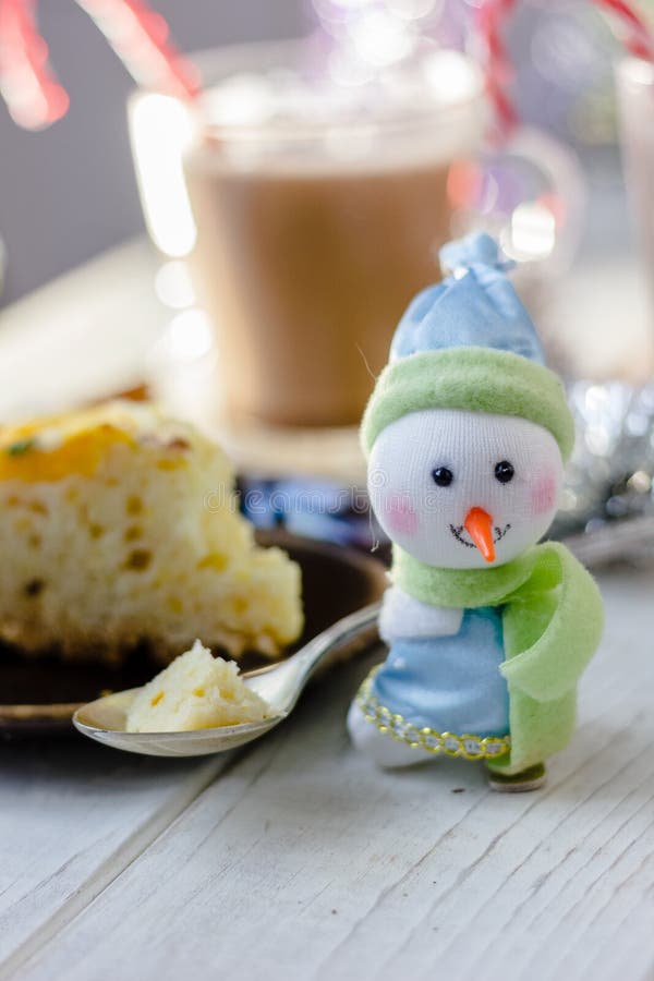 Christmas snowman holding metal spoon with the piece of christmas pie. Christmas snowman holding metal spoon with the piece of christmas pie