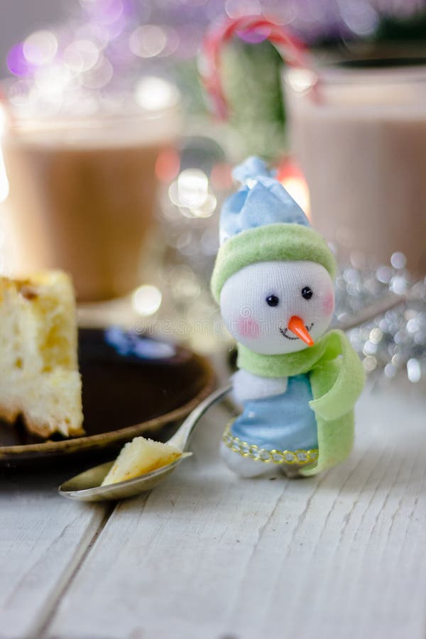 Christmas snowman holding spoon with christmas pie in hands. Christmas snowman holding spoon with christmas pie in hands