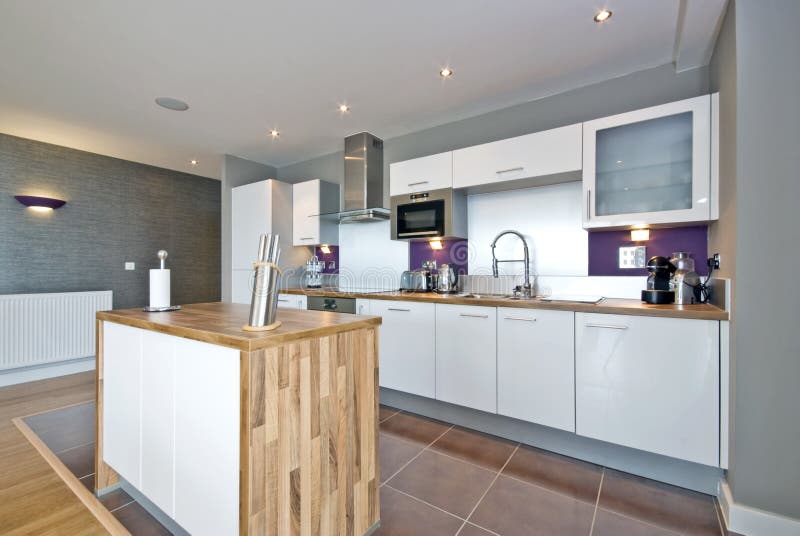 Luxurious fully fitted kitchen with appliances in white. Luxurious fully fitted kitchen with appliances in white