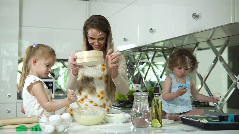 Cucina familiare. madre con figlie che prepara l'impasto per il forno stock footage