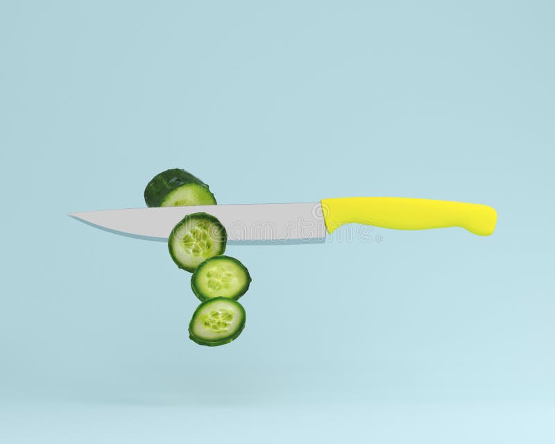 Cucumber cut into pieces with stainless kitchen knives on blue p