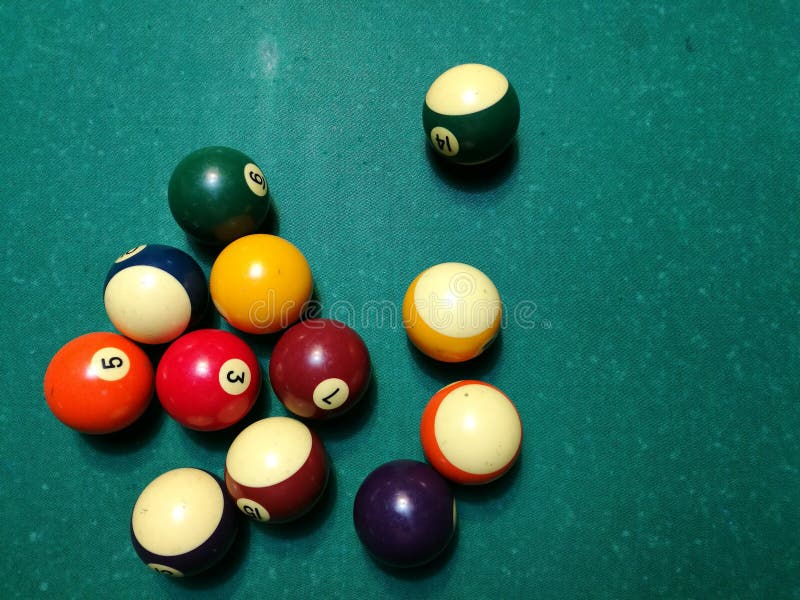 Cue aim billiard snooker pyramid on green table. A Set of snookers/pool balls on Billiards table.