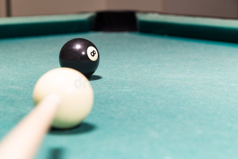 Cue Aiming Black Ball into Snooker Billards Table Pocket Stock Image