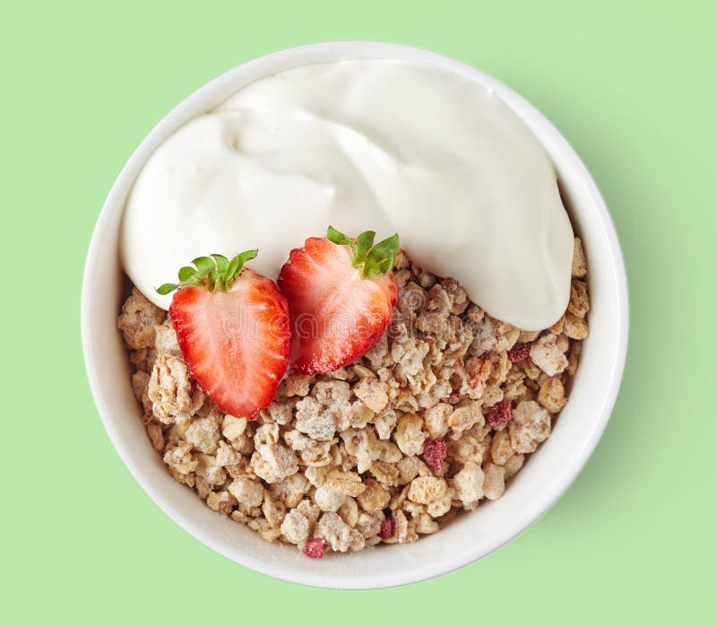 Cuenco de muesli entero del grano en fondo verde fotografía de archivo Cuenco de muesli entero del grano en fondo verde fotografía de archivo