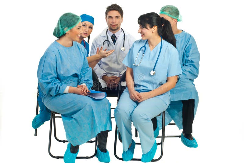 Five doctors sitting on chairs and having a conversation before the seminar starting isolated on white background. Five doctors sitting on chairs and having a conversation before the seminar starting isolated on white background