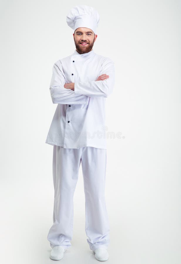 Cuisinier masculin de sourire de chef se tenant avec des bras pliés images stock Cuisinier masculin de sourire de chef se tenant avec des bras pliés images stock