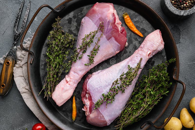 Raw turkey thigh with spices set, on gray stone table background, top view flat lay. Raw turkey thigh with spices set, on gray stone table background, top view flat lay