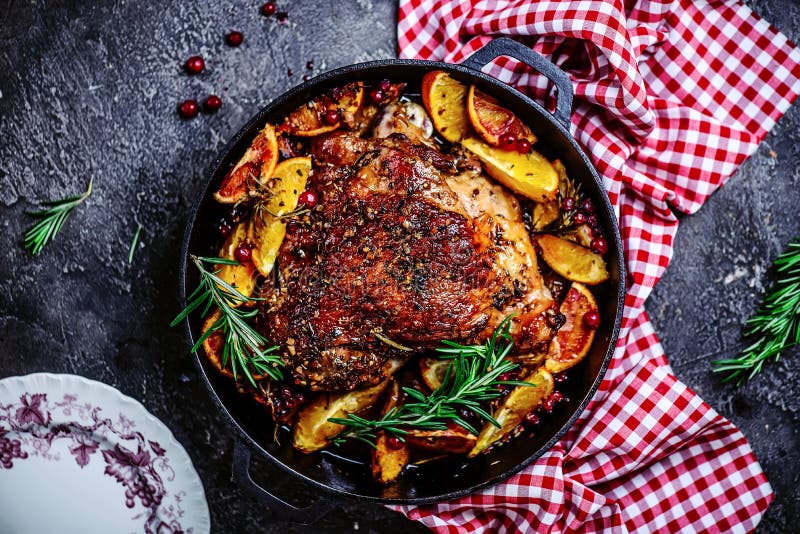 Turkey thigh baked with oranges and cranberries...style rustic.selective focus. Turkey thigh baked with oranges and cranberries...style rustic.selective focus