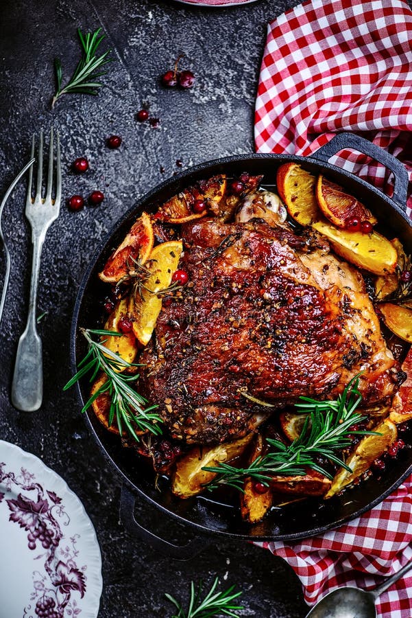 Turkey thigh baked with oranges and cranberries...style rustic.selective focus. Turkey thigh baked with oranges and cranberries...style rustic.selective focus