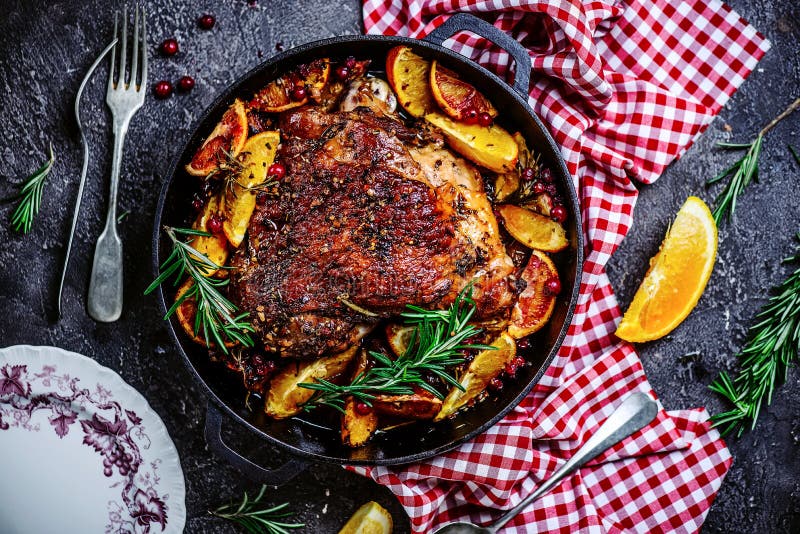 Turkey thigh baked with oranges and cranberries...style rustic.selective focus. Turkey thigh baked with oranges and cranberries...style rustic.selective focus