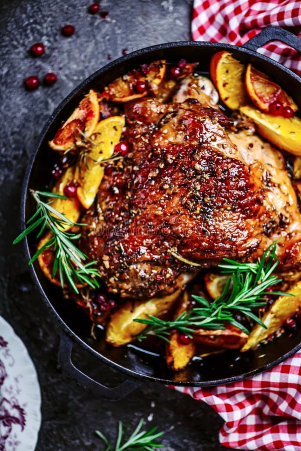 Turkey thigh baked with oranges and cranberries...style rustic.selective focus. Turkey thigh baked with oranges and cranberries...style rustic.selective focus